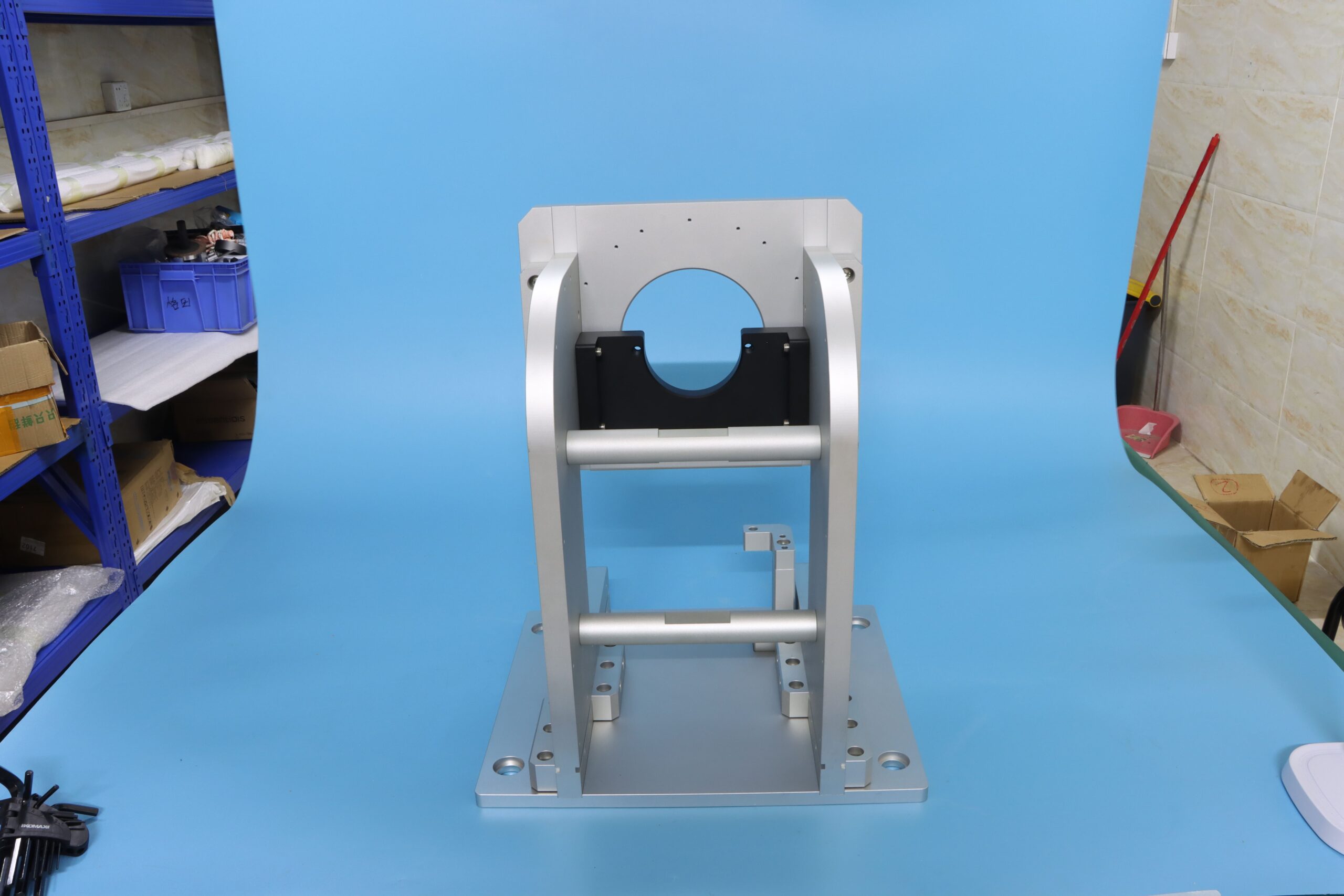 Precision CNC machined aluminum assembly fixture and mounting bracket component with anodized finish.
