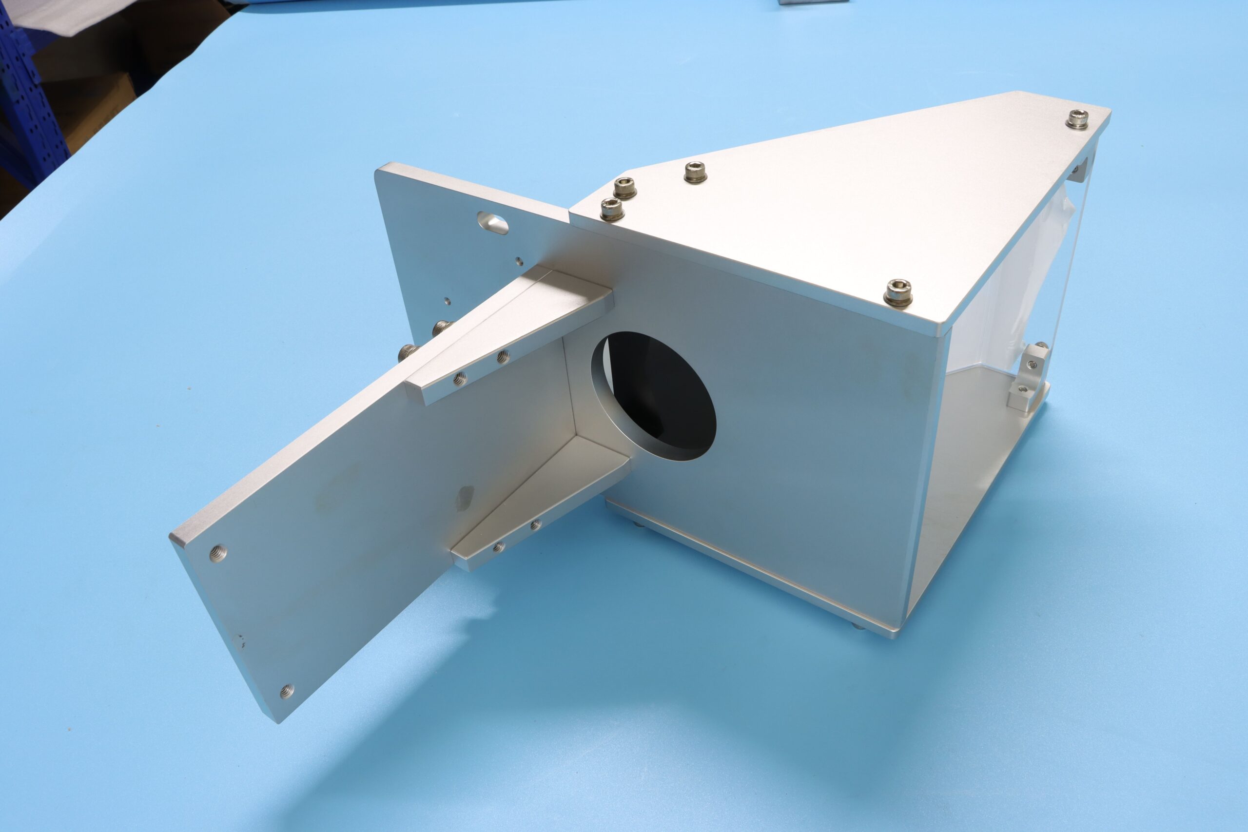 Precision custom aluminum sheet metal enclosure and assembled bracket component with anodized surface treatment.