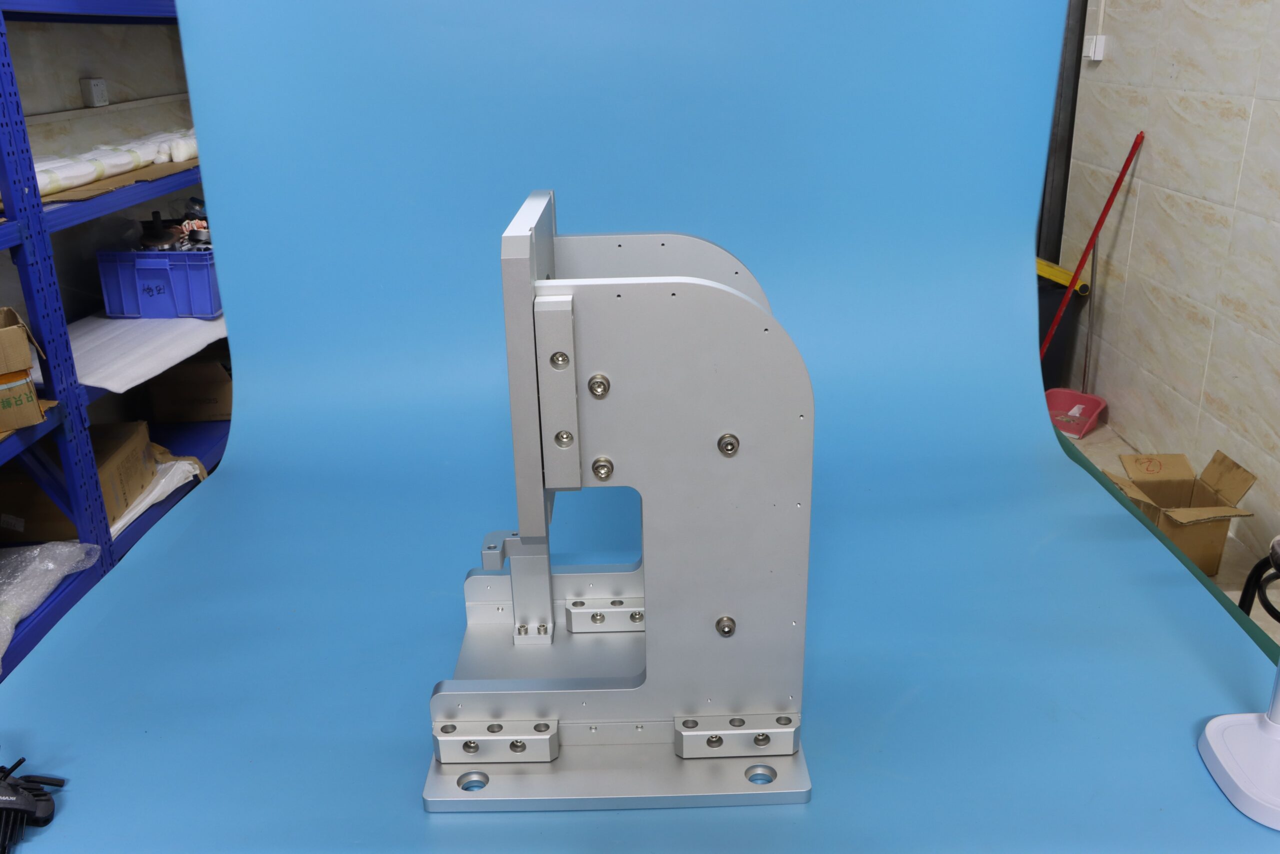 Side view of a custom CNC machined aluminum structural mounting bracket with precise bolt holes.